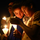 People attending a candlelight vigil in honor of the El Paso victims